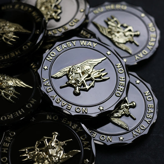 Collection of 'No Easy Day' coins with military emblem on a dark background