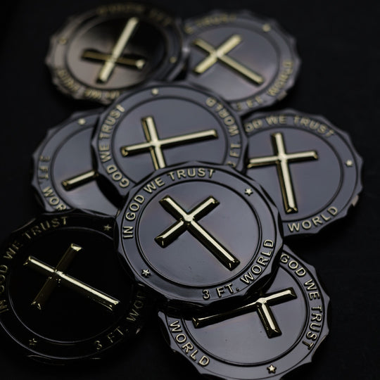 Dark metallic coins with gold crosses and text on a black background