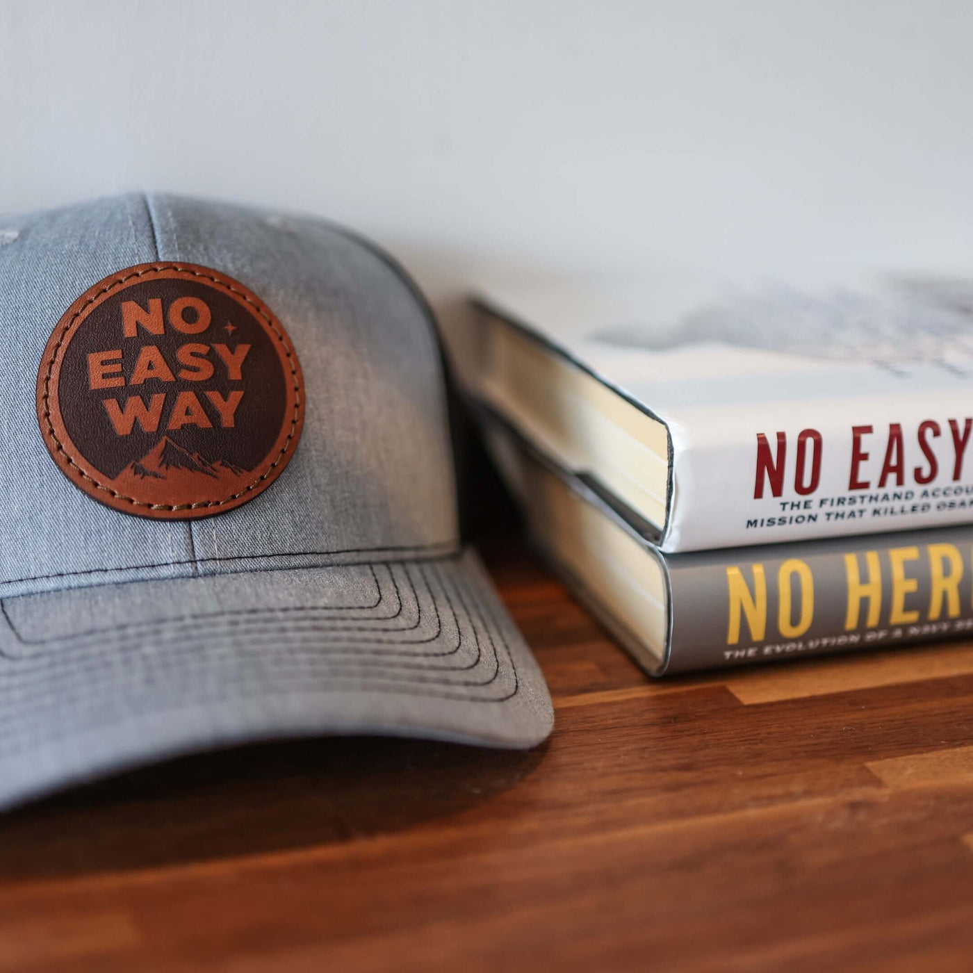 No Easy Way Leather Trucker Hat on bookshelf